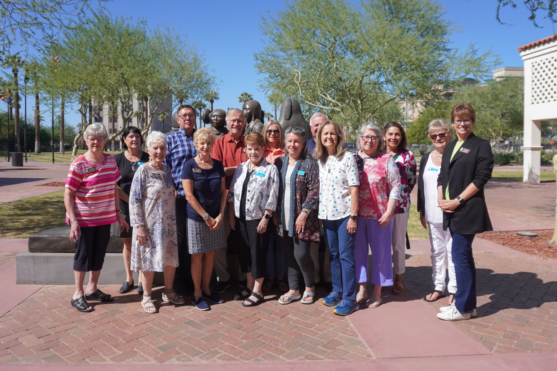A group of people posing for a picture in front of a fountain.