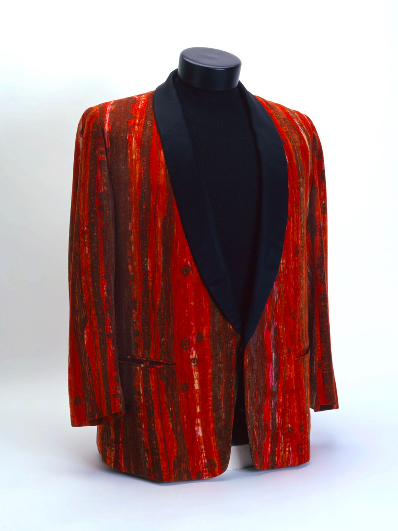 A red and black tuxedo jacket on a mannequin.