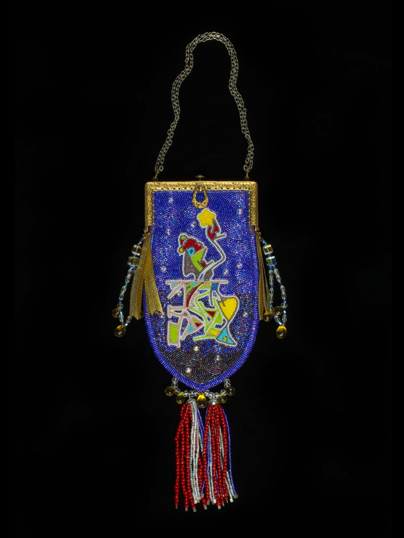 A blue and gold purse with tassels.