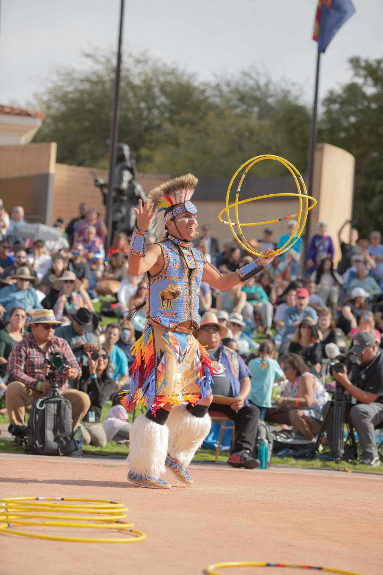 A Native American dancer performs a hoop dance.