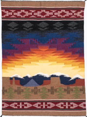 A colorful pictorial textile of a sunrise over mountains.