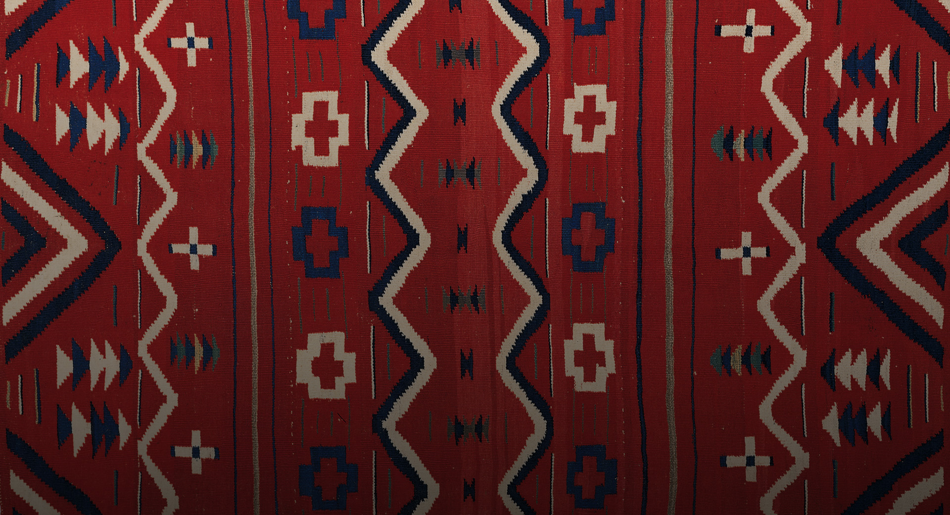 A red and blue Navajo textile.