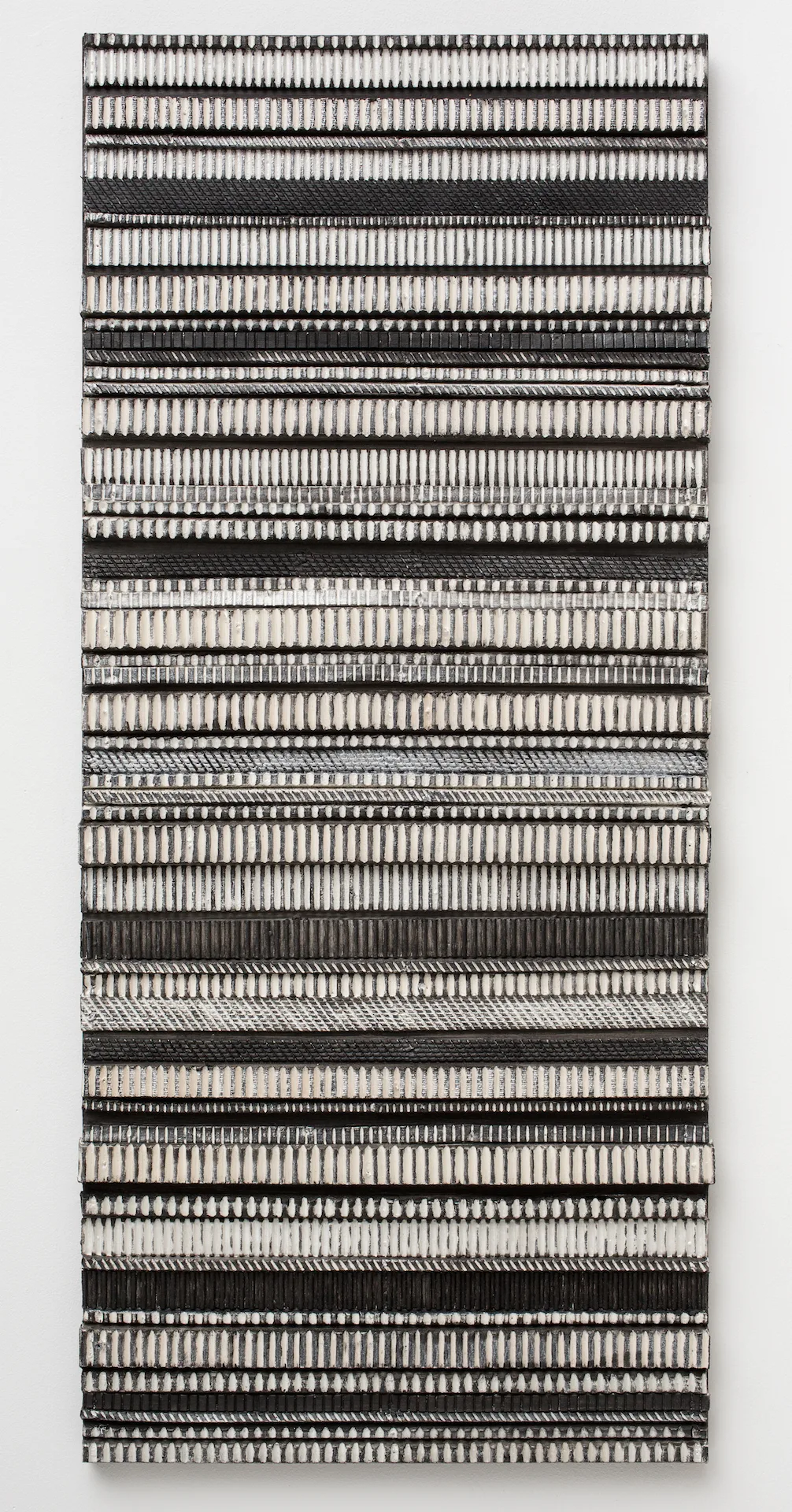 A black and white piece of art hanging on a wall.