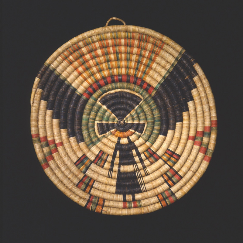 A woven basket with an eagle on it.