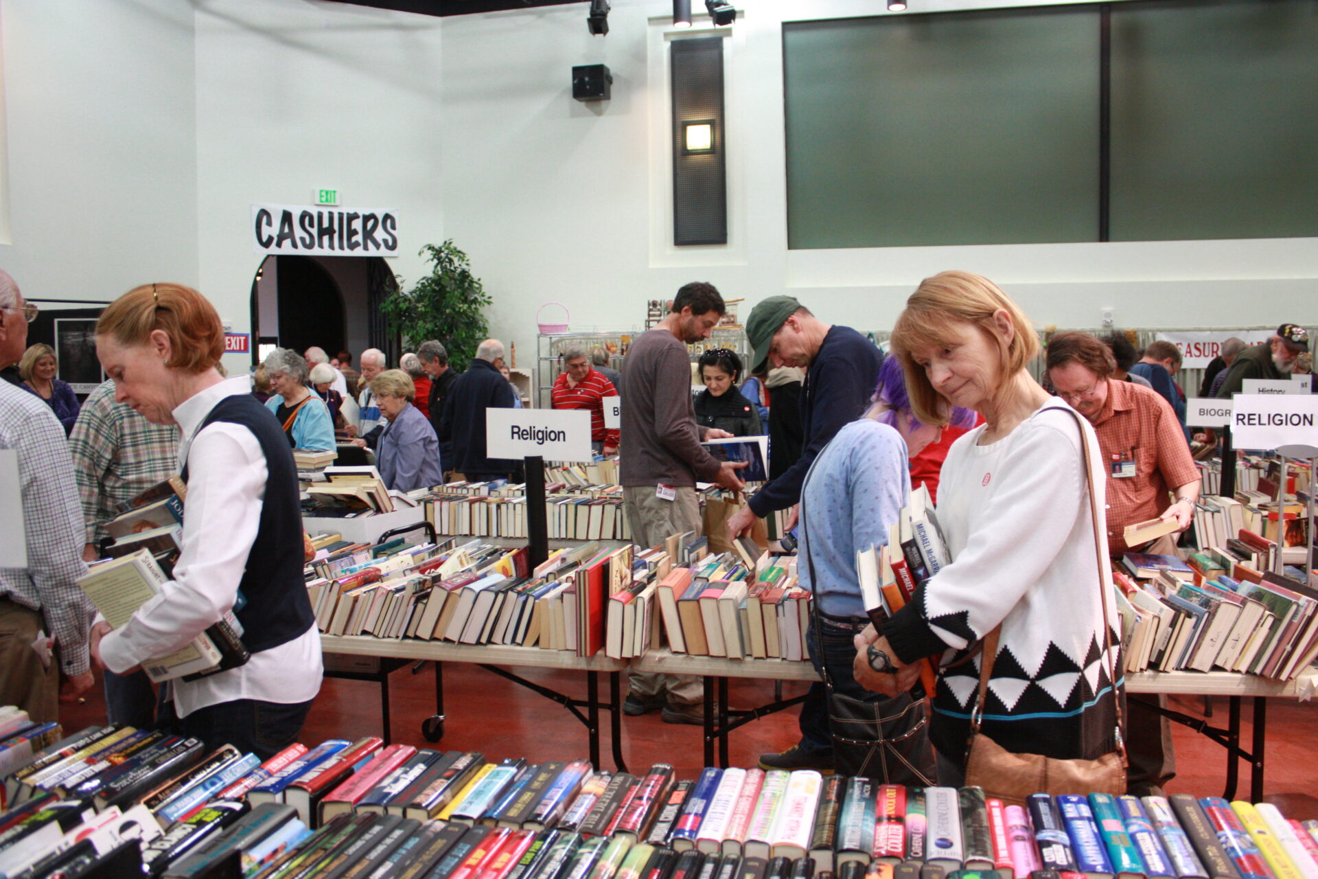A group of people at a book sale.