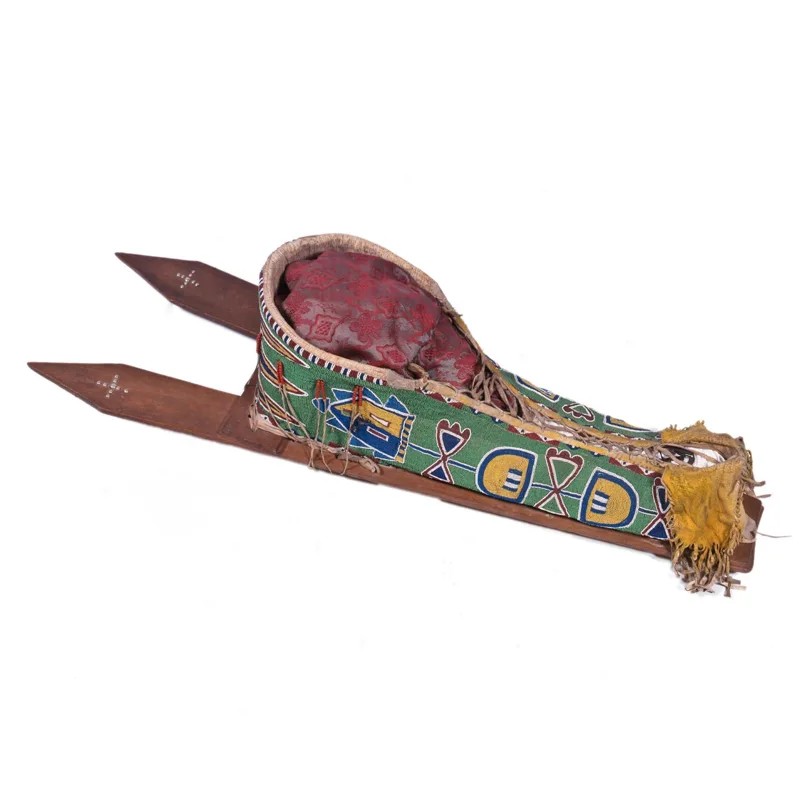 A wooden lattice cradle with a colorful design on it.