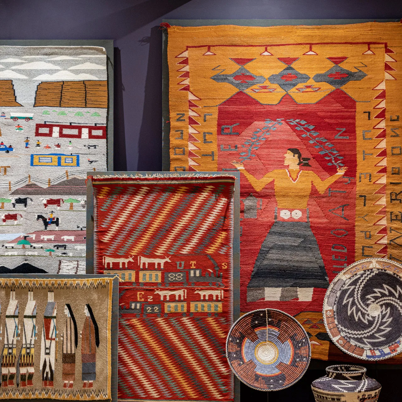 A group of Native American woven baskets and textiles.