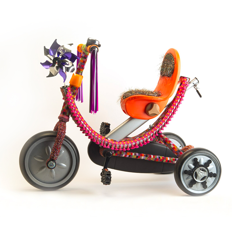A bead designed tricycle with a colorful seat and wheels.