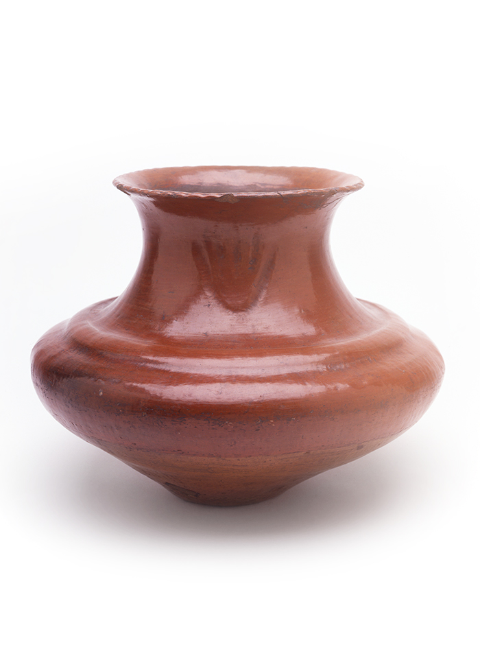 A small brown pottery artwork with a flat lip on a white background.