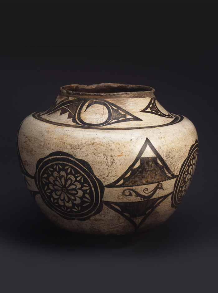 A black and white jar with designs on it.
