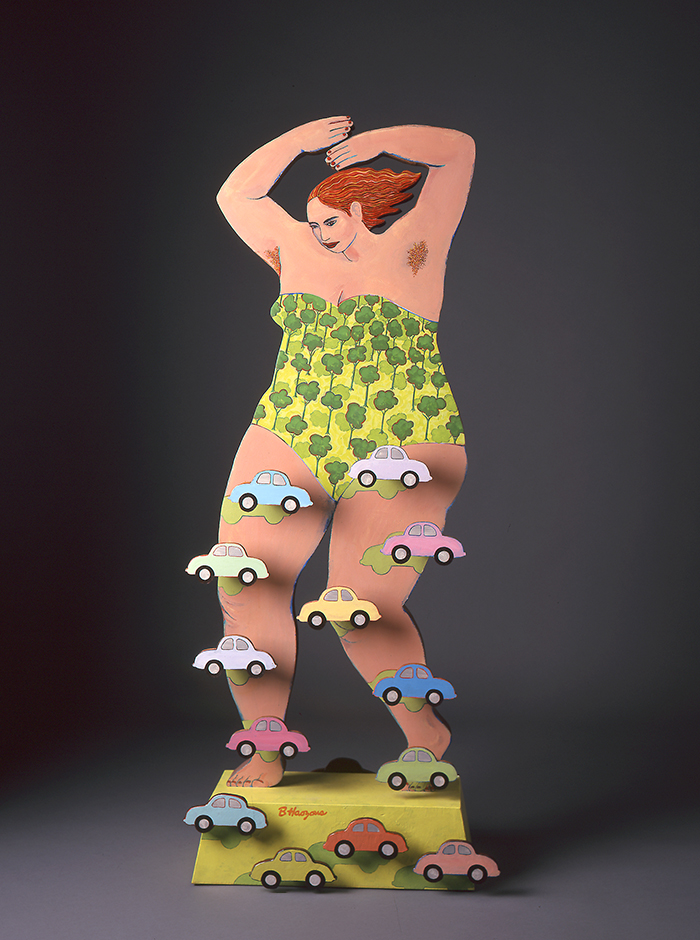 A sculpture of a woman in a one piece bathing suit standing on a yellow platform with cars on her legs.