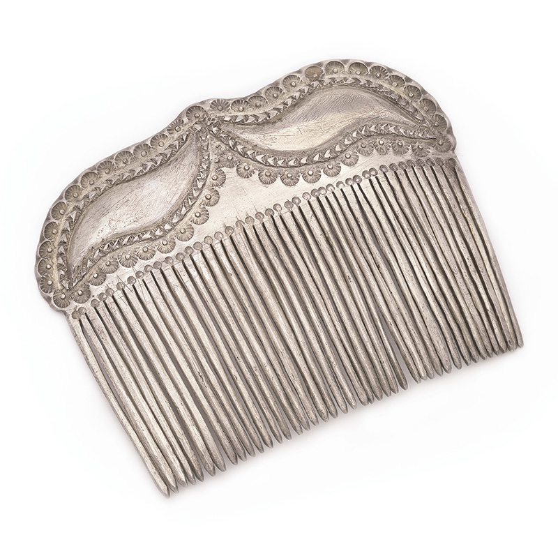 A silver hair comb on a white background.