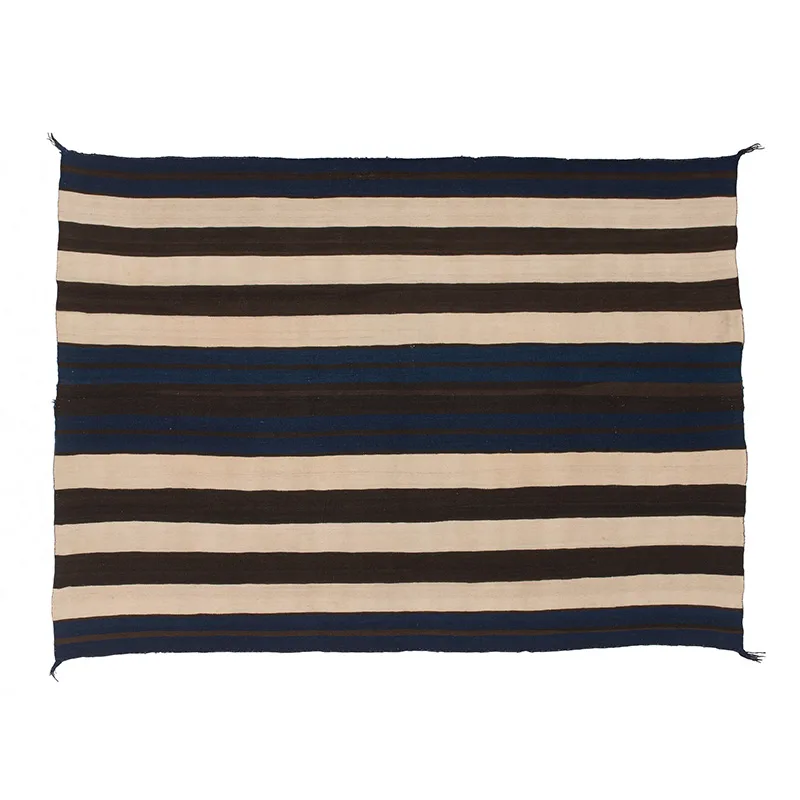 A blue and black striped Diné blanket on a white background.