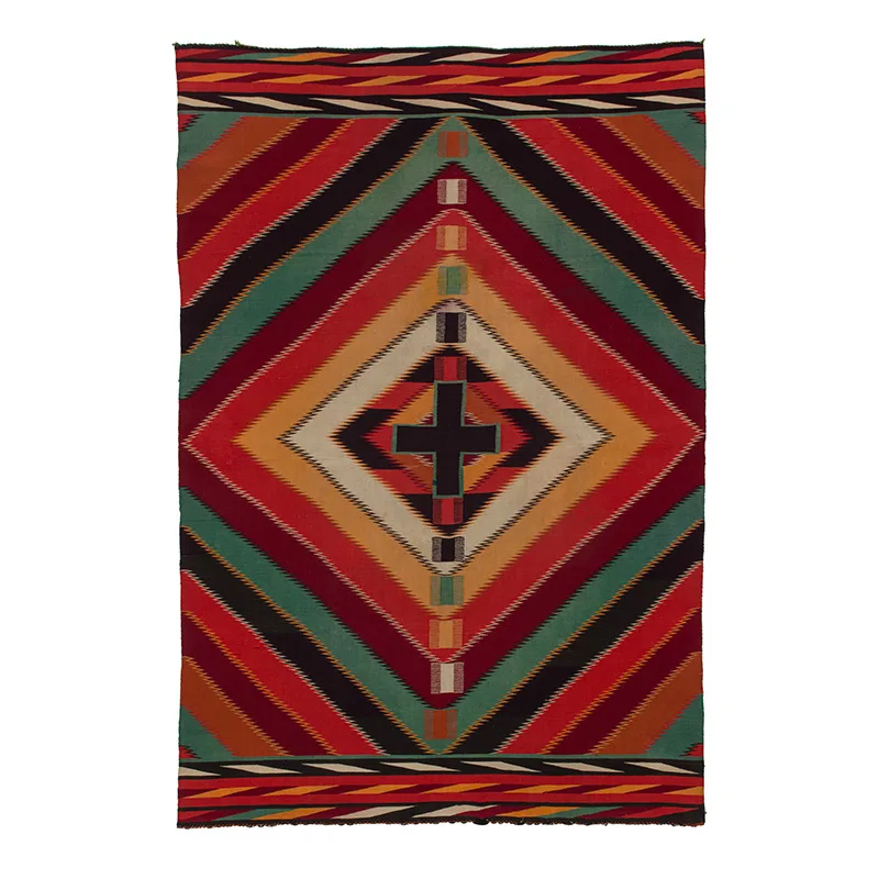 A colorful Diné textile with a cross on it.
