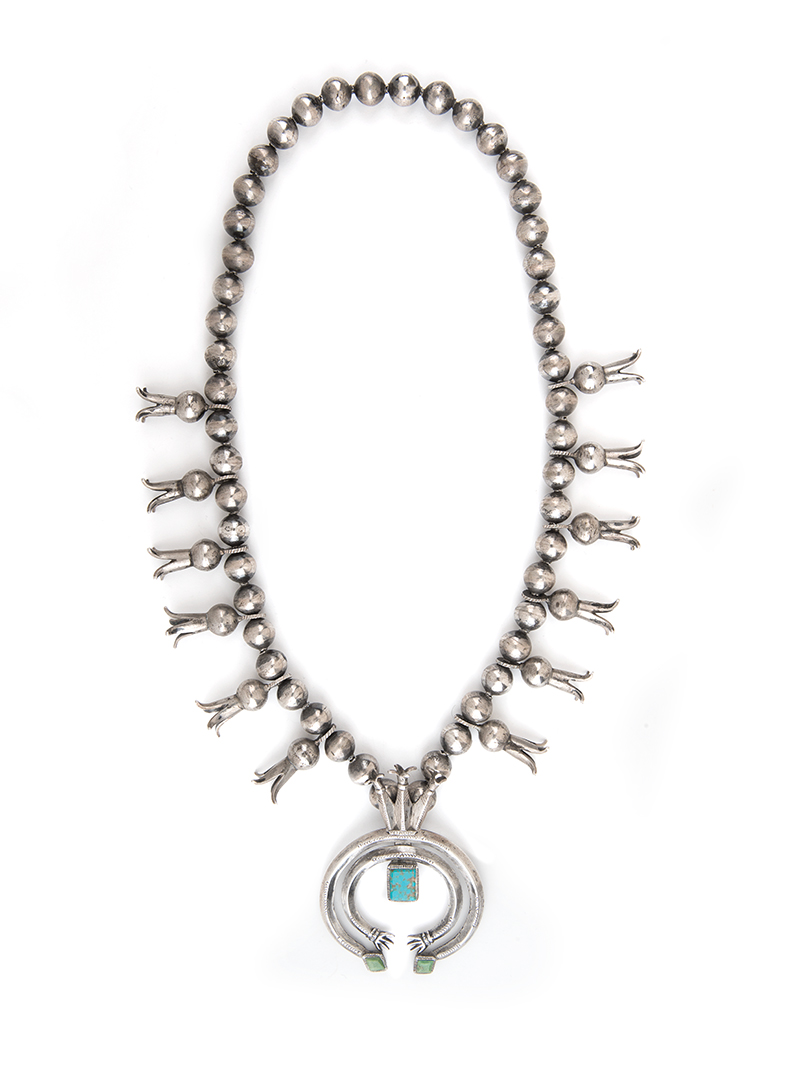 A silver necklace with turquoise stones.