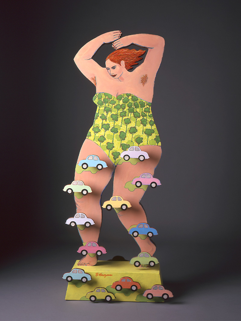A sculpture of a woman in a one piece bathing suit standing on a yellow platfrom with cars on her legs.