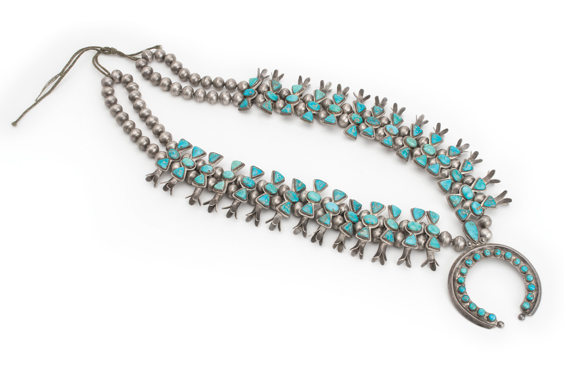 A turquoise and silver necklace with a crescent moon.