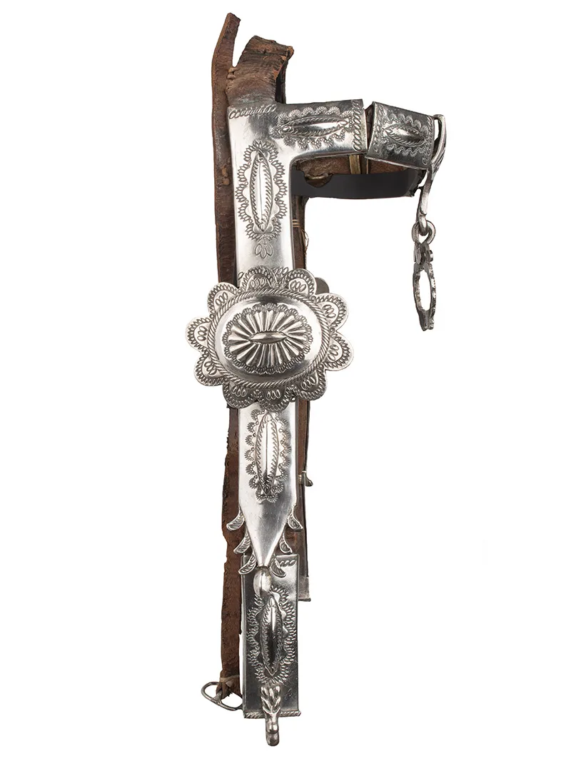 A silver bridle with a silver buckle.
