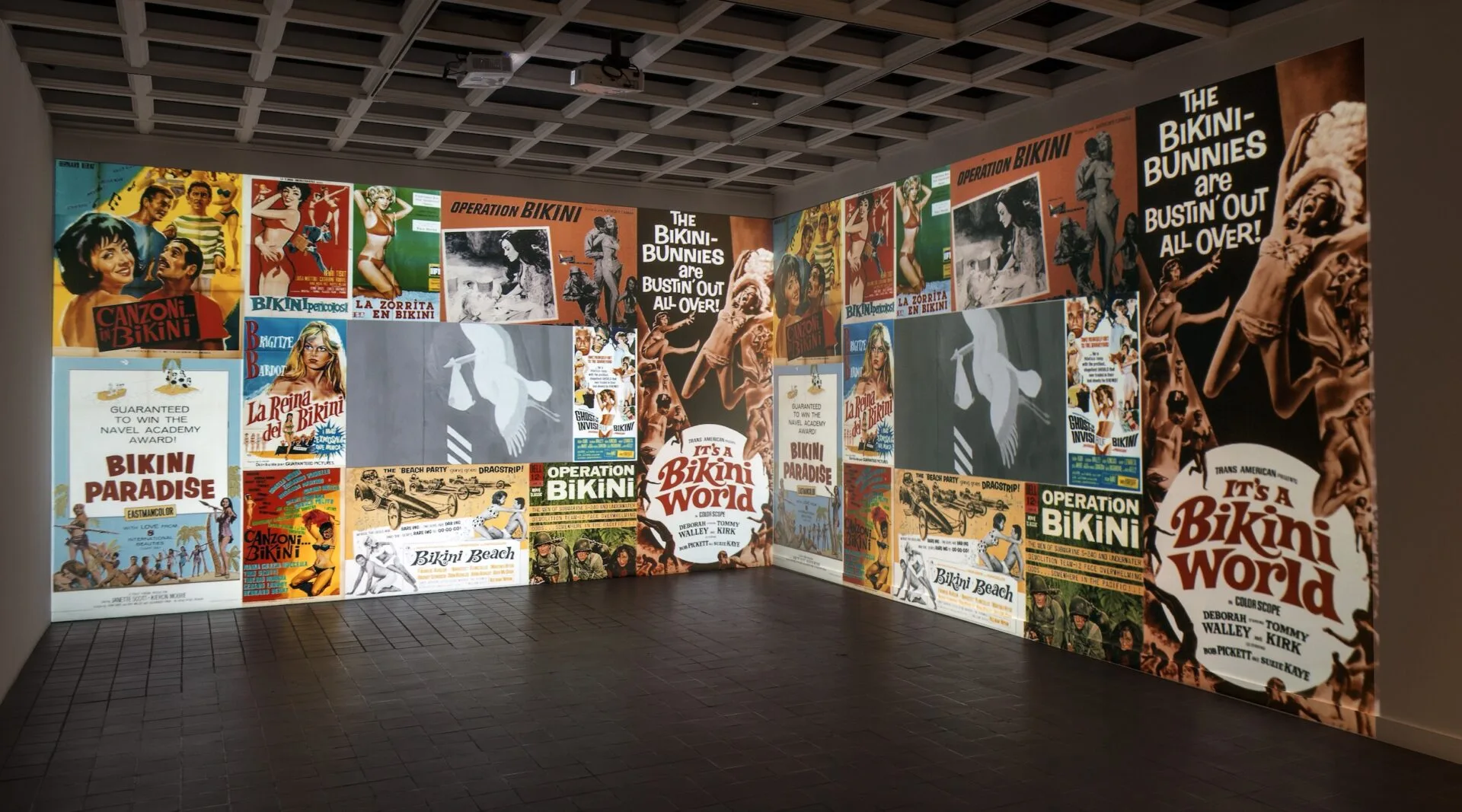 A room full of movie posters on the wall.