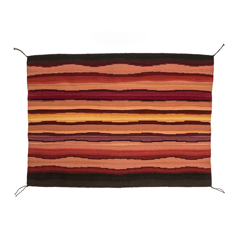 A red, orange, and brown striped textile hanging on a white background.