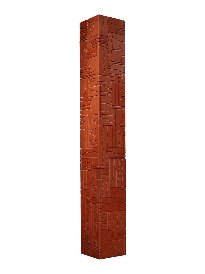 A tall red wooden totem sculpture on a white background.