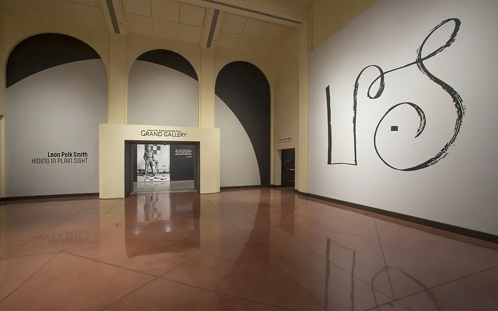 A room with black and white drawings on the wall.