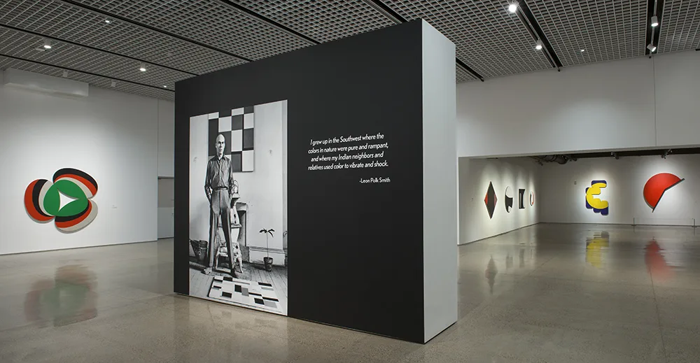 A black and white photo on a wall in an art gallery.