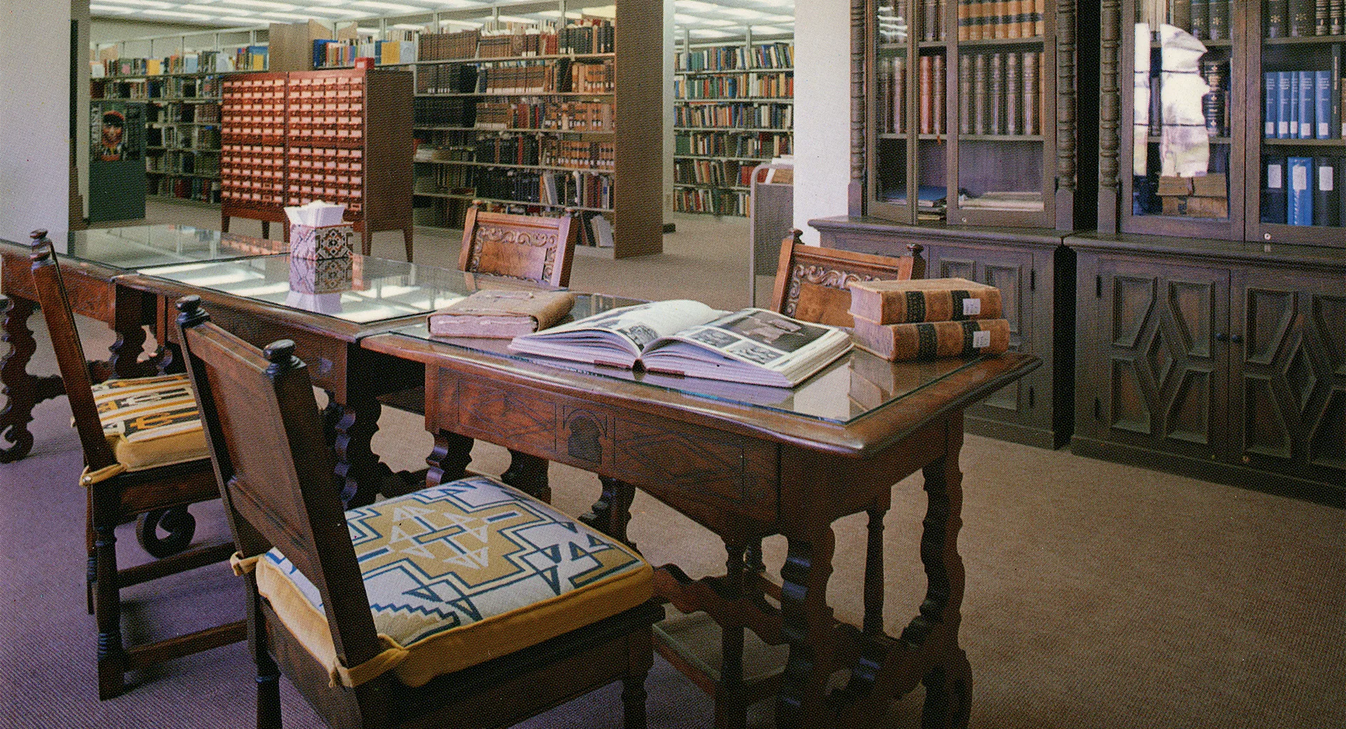 A table with books on it in a library.