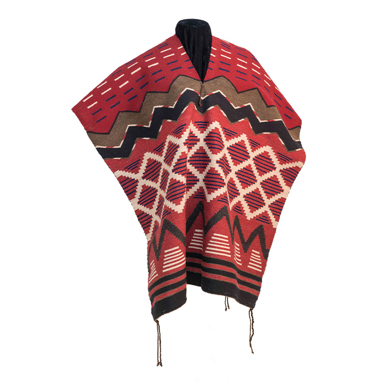 A red, brown, and black poncho on a mannequin.