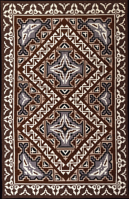 A brown and white tapestry with an ornate design.