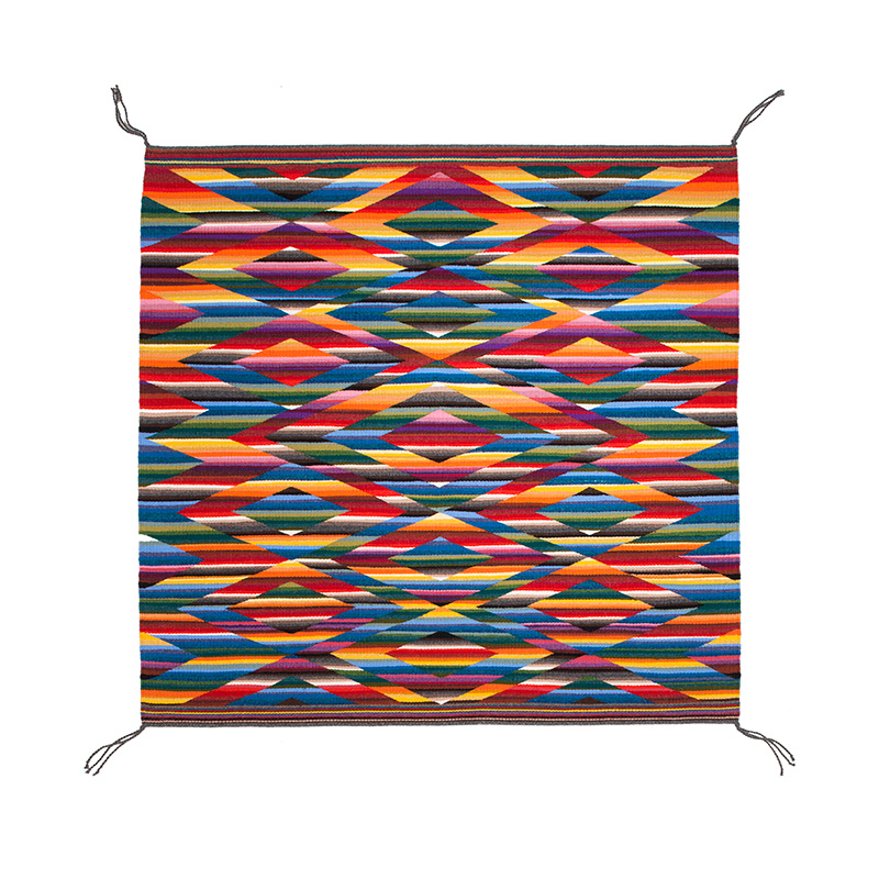 A colorful Diné textile with geometric designs.