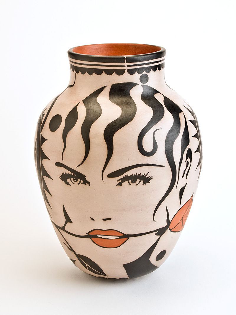 A jar with a woman's face painted on it.
