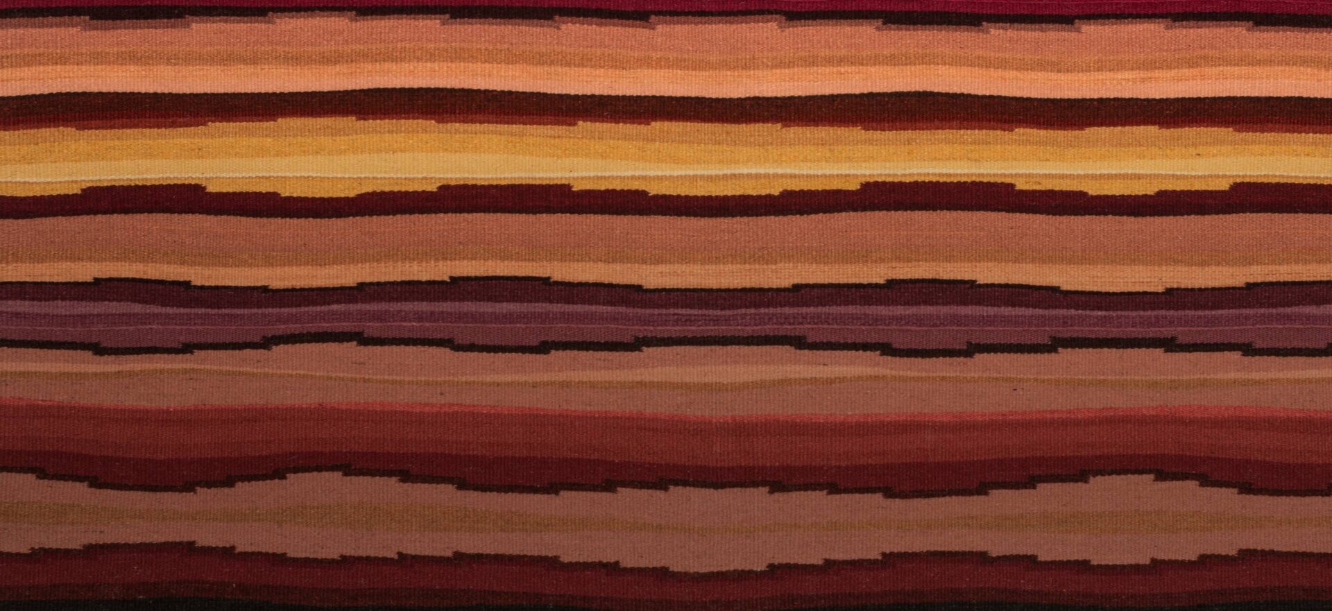 A textile with red, orange, and brown stripes.