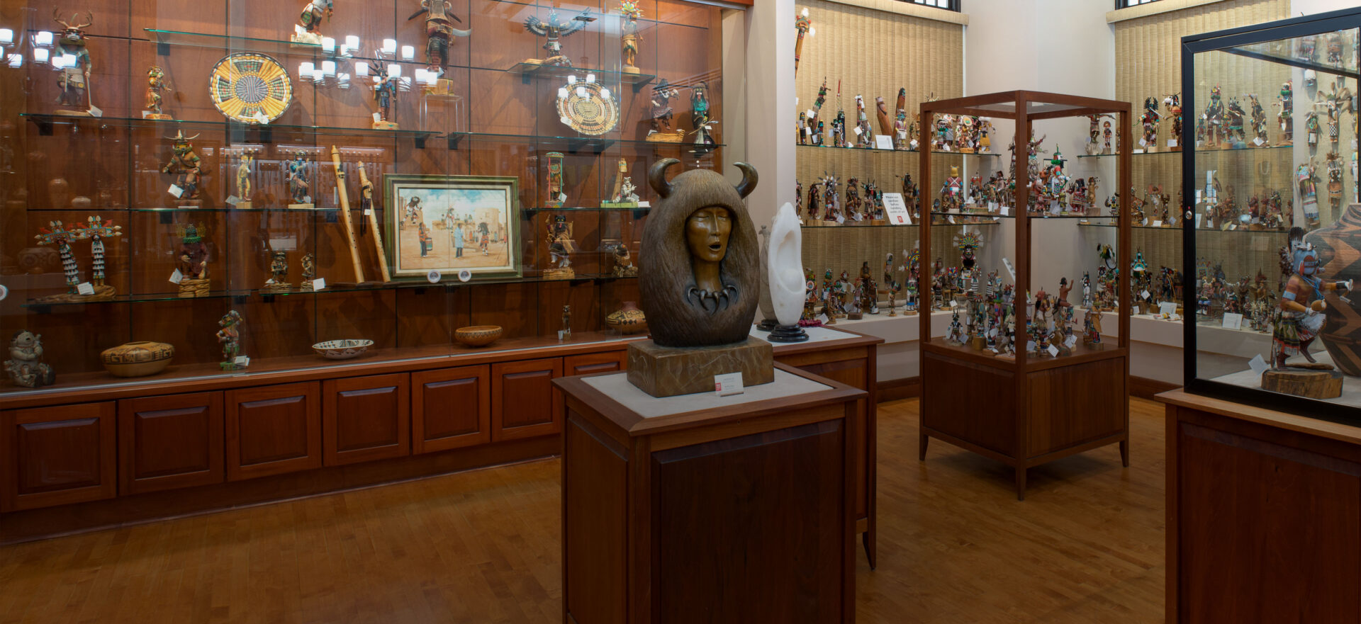 A room with a lot of figurines, sculptures and objects on display.