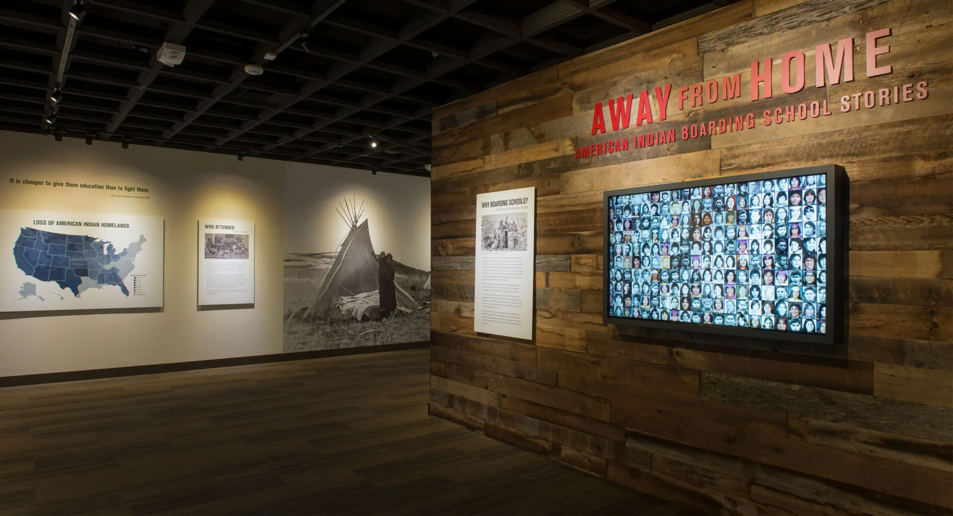 Away From Home exhibit with a wooden wall and a map on it.