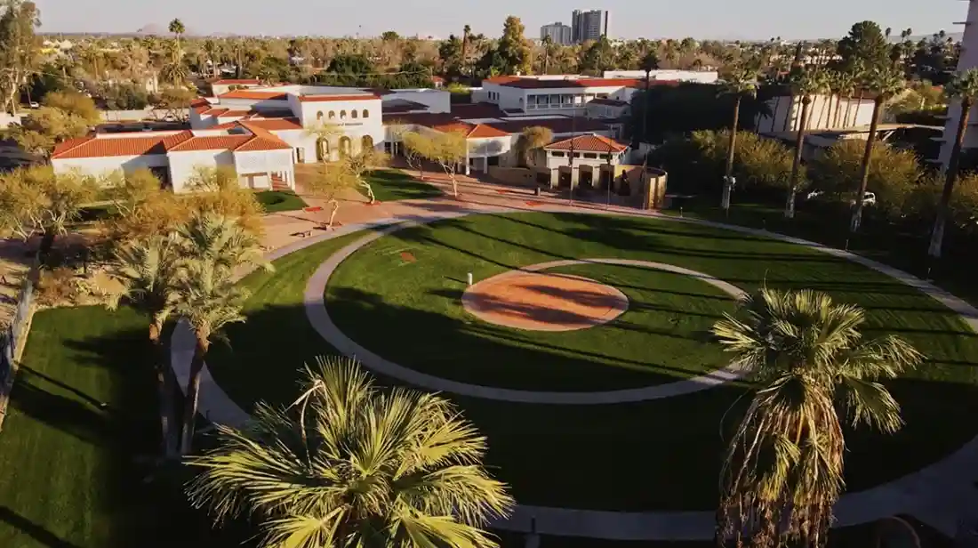 An aerial view of the Heard Museum with palm trees and green grass.