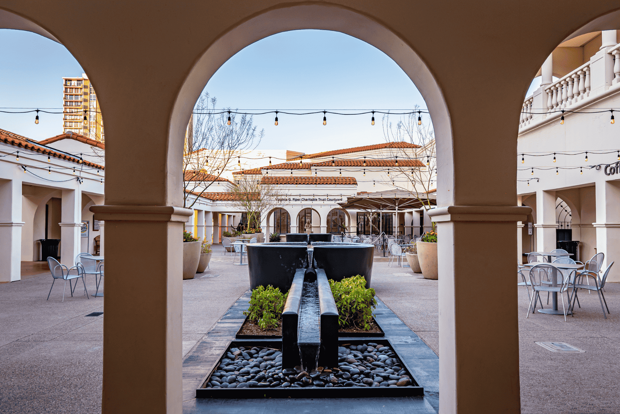 A courtyard with a fountain in the middle of it.