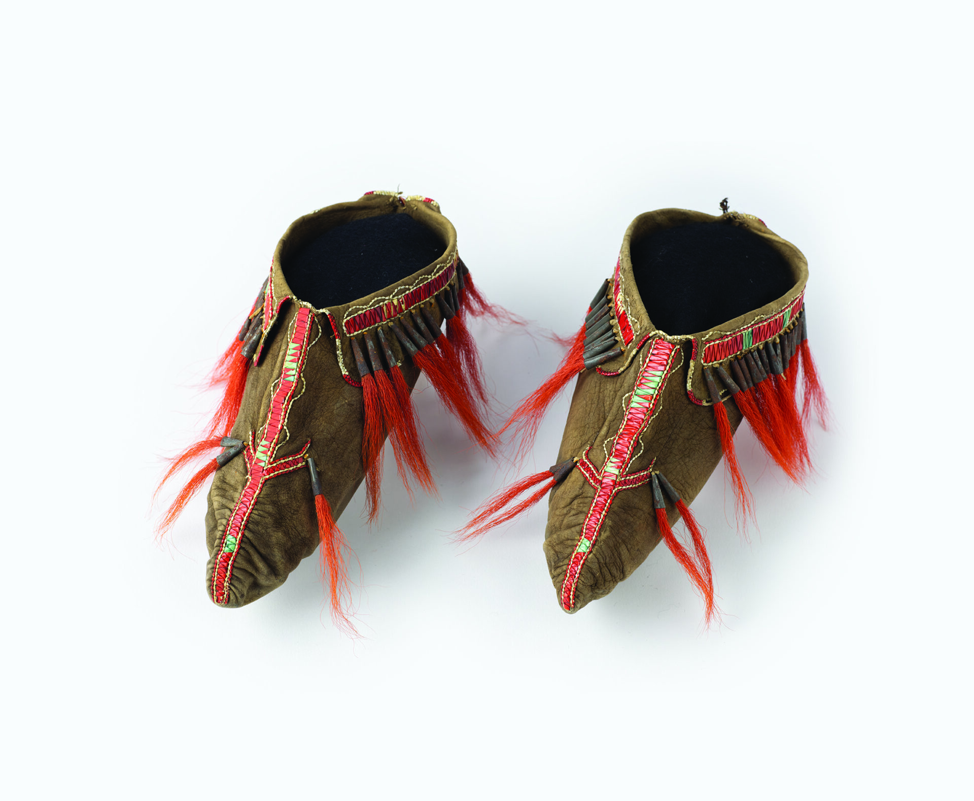 A pair of shoes with red and brown feathers.