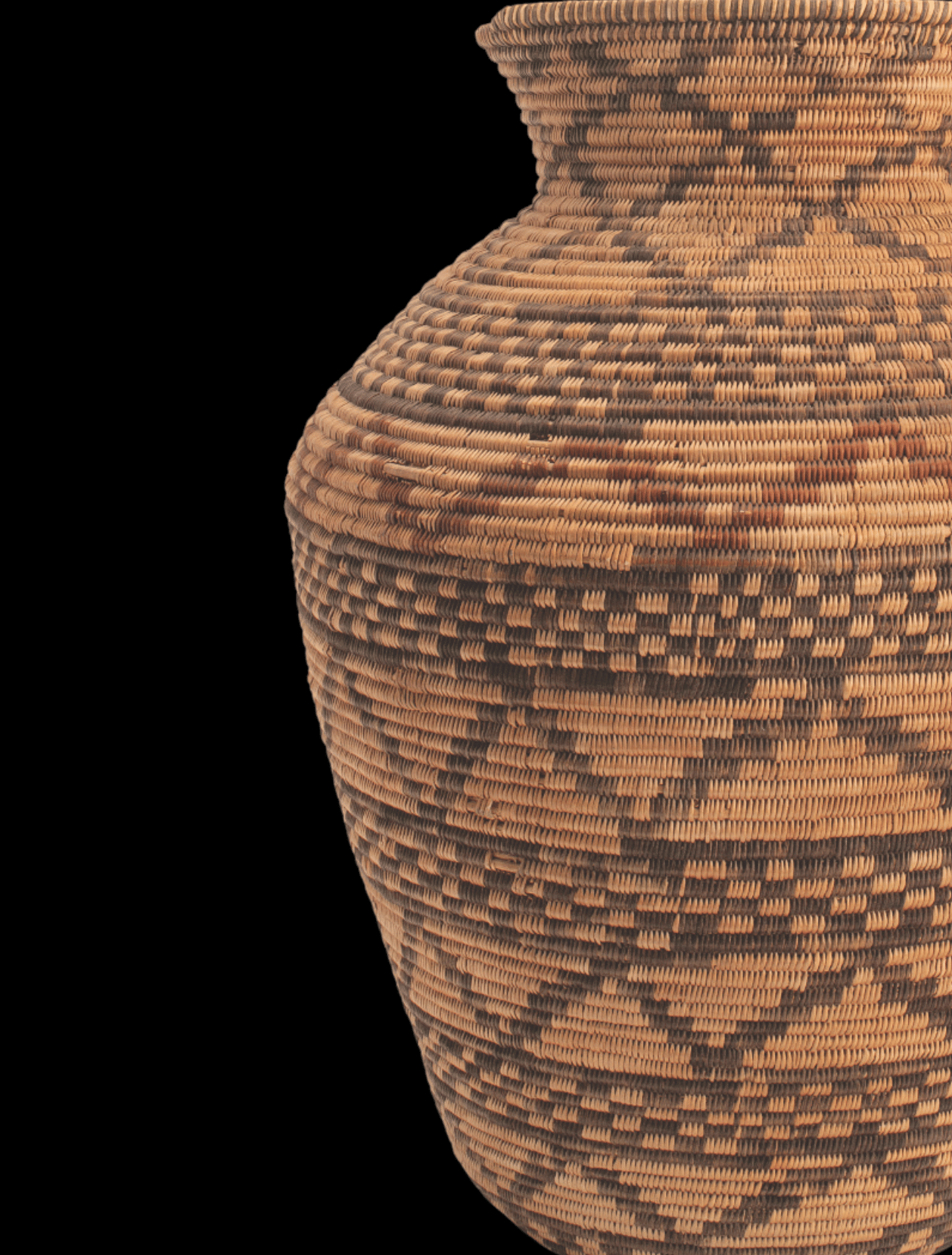 A woven basket on a black background.