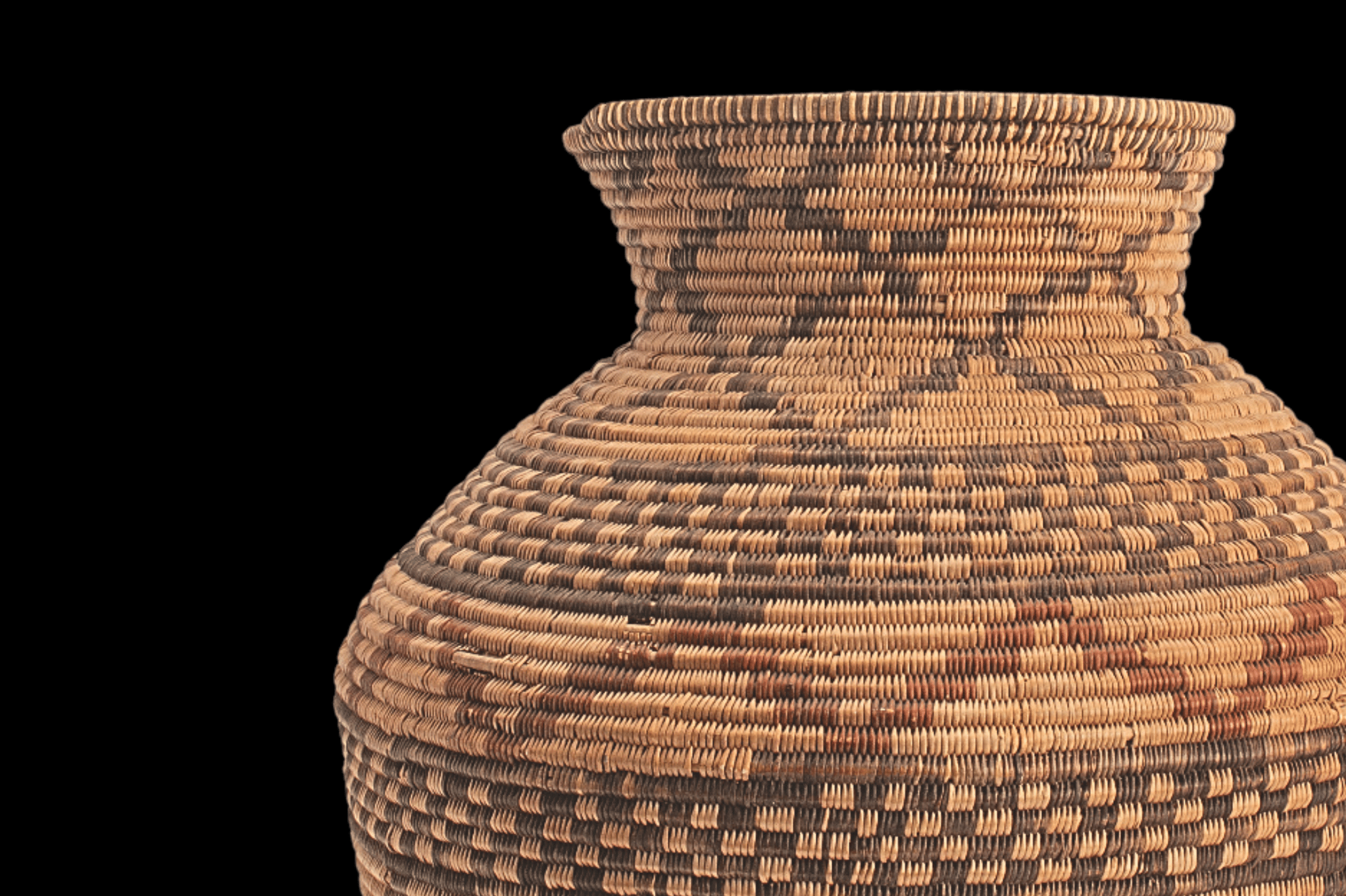 A woven basket on a black background.