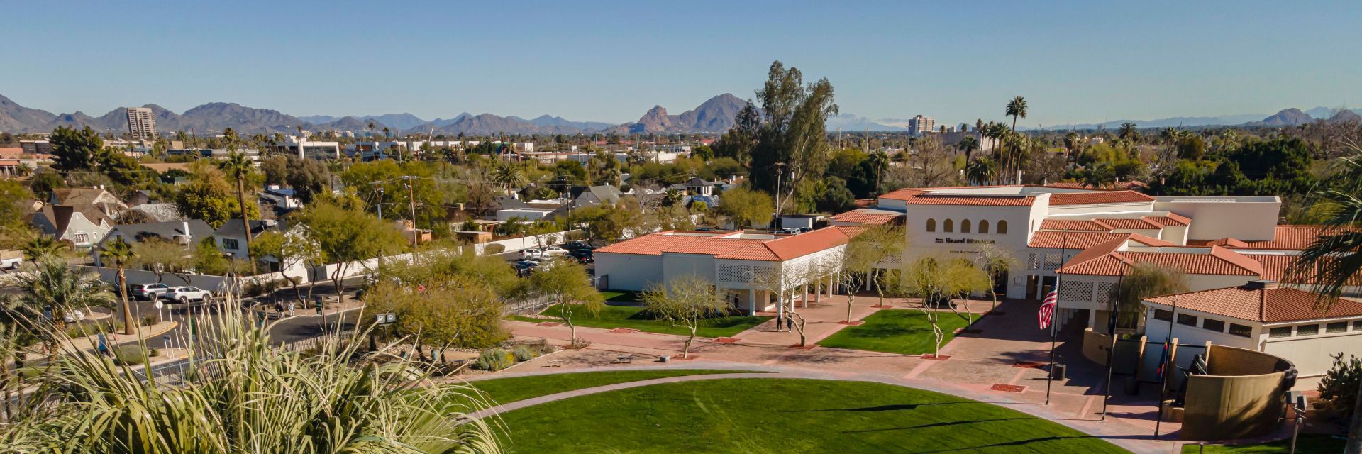An aerial view of Heard campus with trees and mountains in the background.