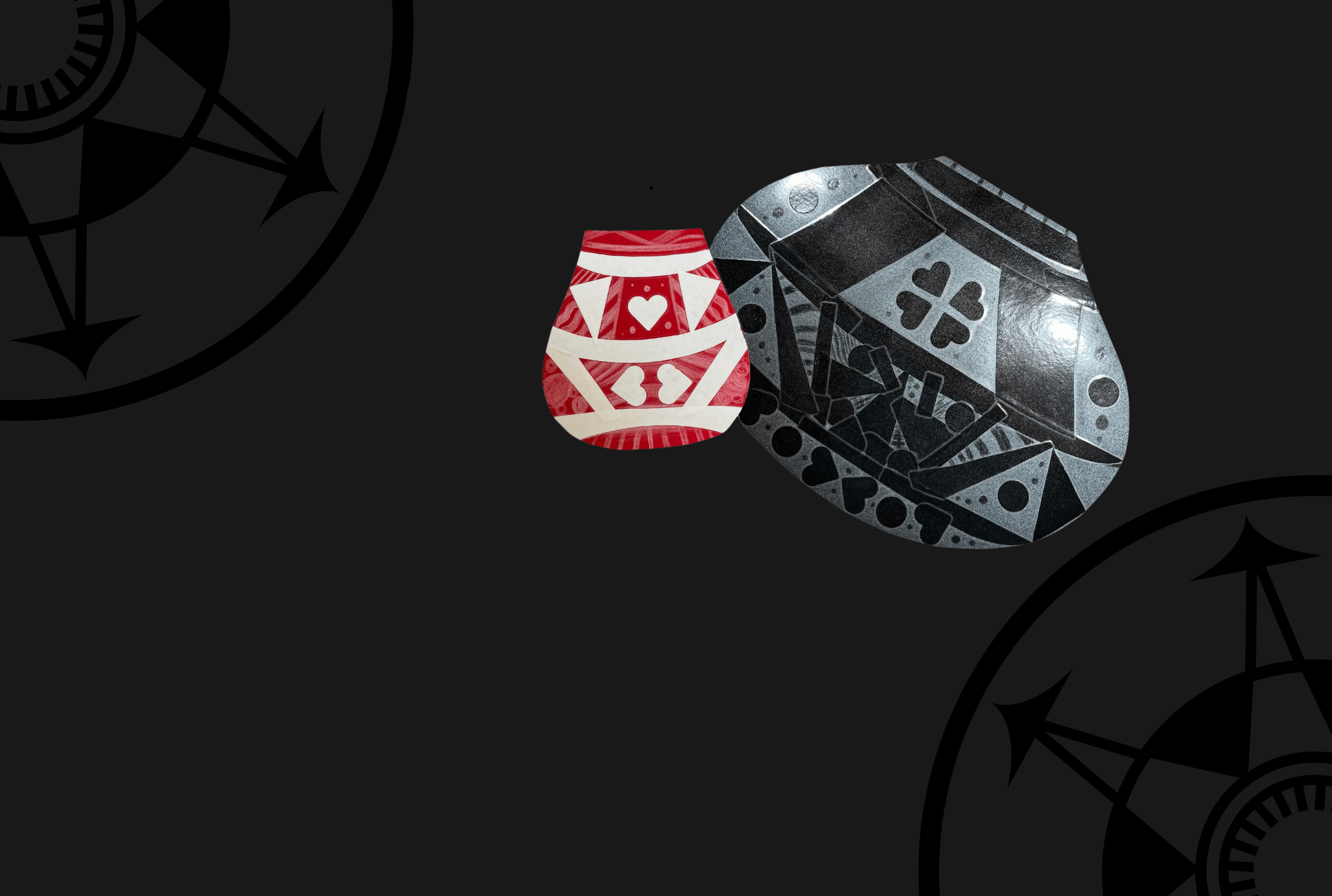 Two geometrically patterned shields, one red and one gray, displayed against a dark background with compass motifs.