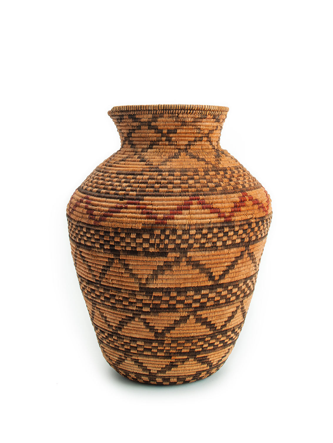 A large, woven basket with intricate patterns in natural brown and black colors, and a slight flared opening at the top.