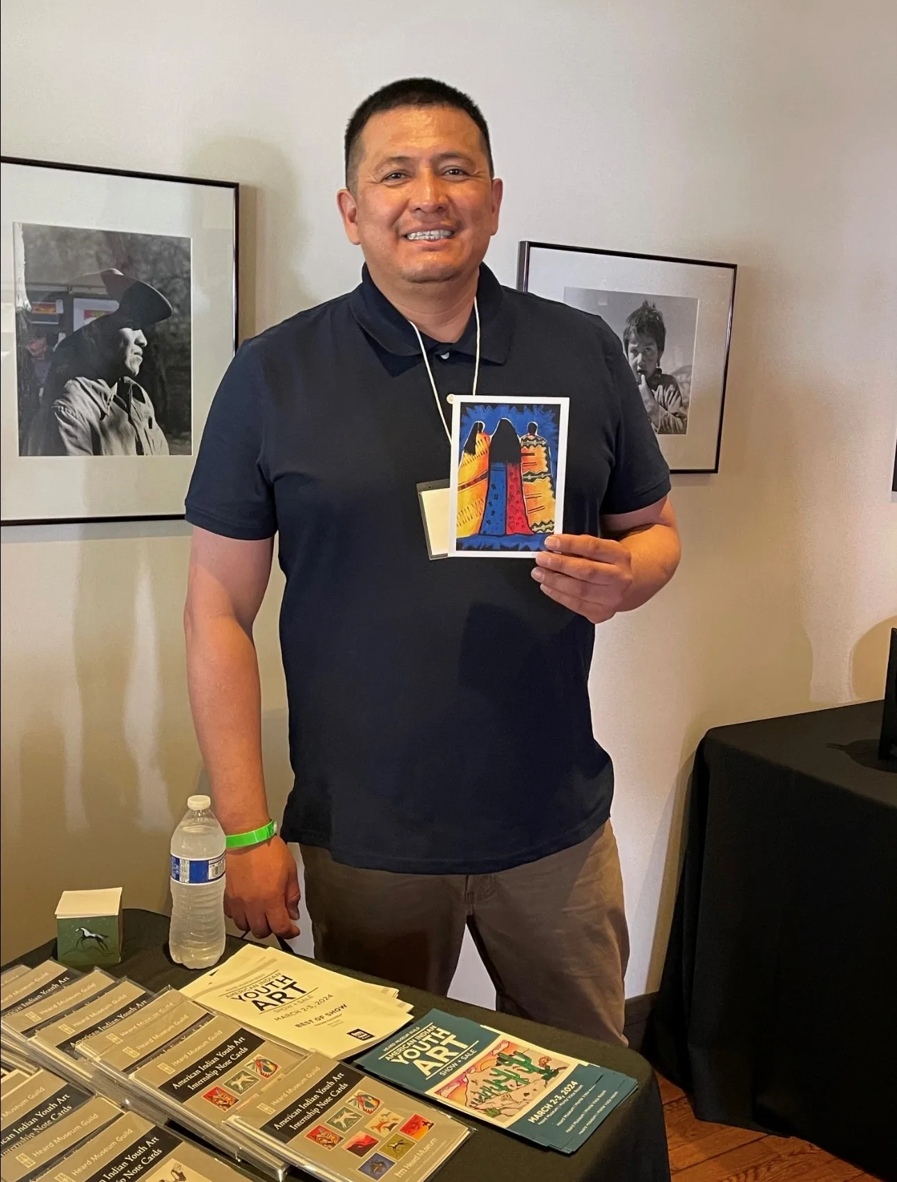 Jay C. McCray showing a student art postcard featuring his winning artwork titled Past, Present, and Future, 2000. Photo courtesy of Jay C. McCray.