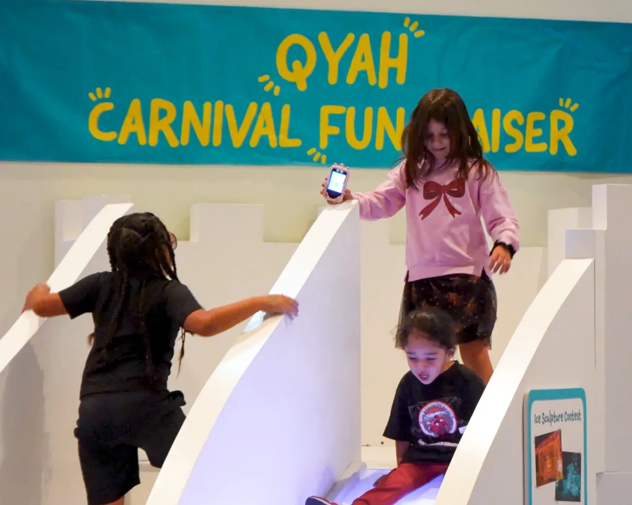 Children on a slide at a play carnival