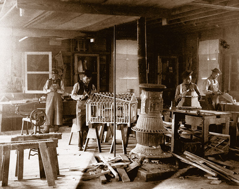 1890 black and white photo of young Native men in a woodworking shop