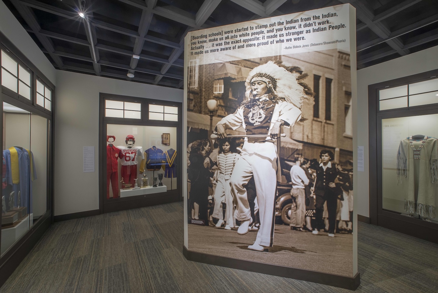American Indian marching band member displayed on a large-scale image in the Away From Home: American Indian Boarding School Stories exhibition.