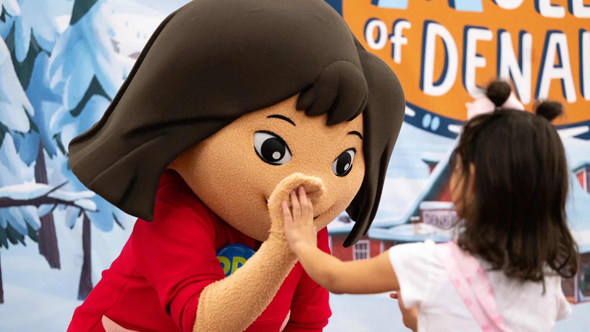 Molly of Denali high-fives a child at the Heard Museum