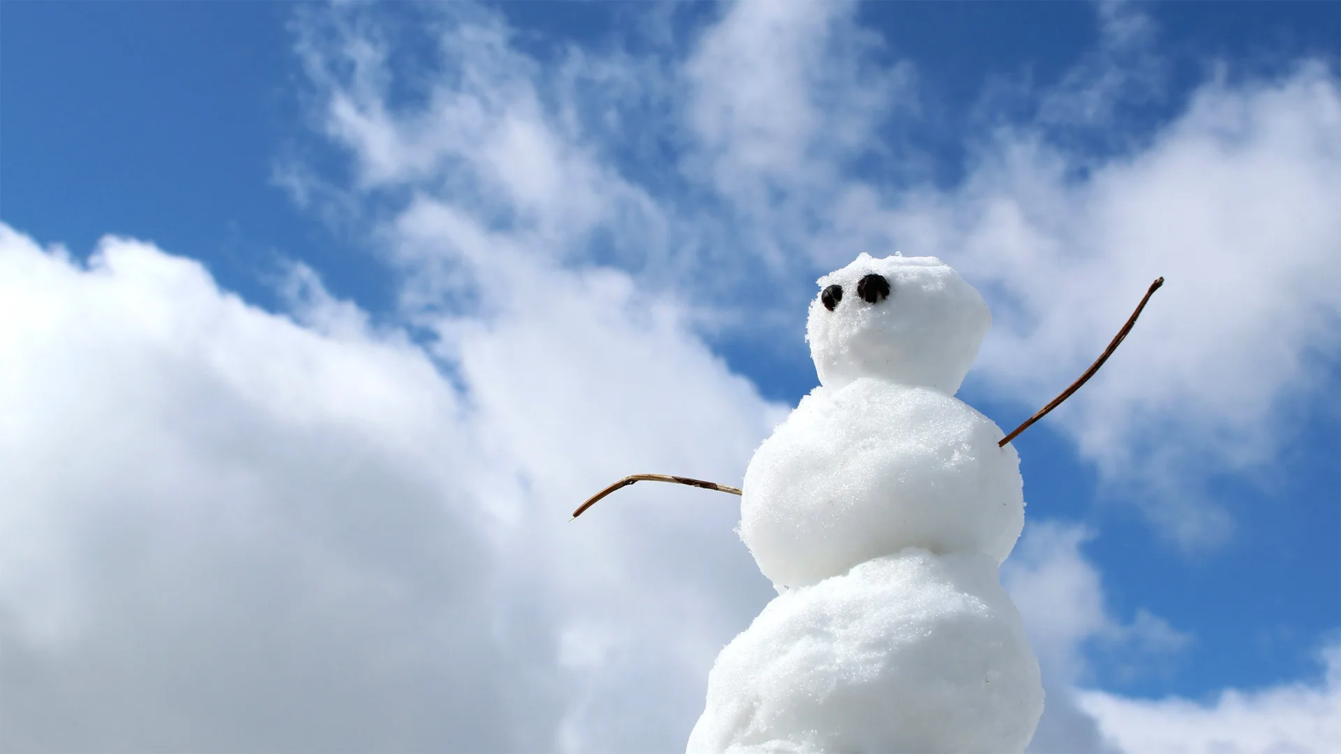 Snowman in front of blue sky